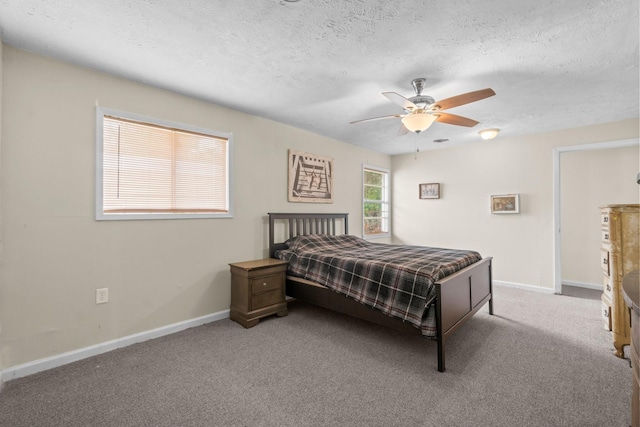 168 Bay Haven Blvd, Livingston, TX 77351 - bedroom featuring baseboards, carpet floors, a textured ceiling, and ceiling fan