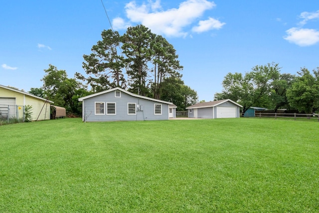 168 Bay Haven Blvd, Livingston, TX 77351 - rear view of property featuring a detached garage and an outbuilding