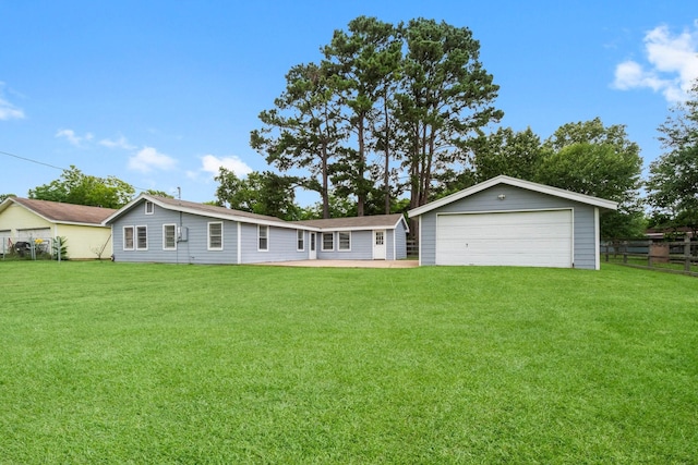 168 Bay Haven Blvd, Livingston, TX 77351 - rear view of property with a garage and an outbuilding