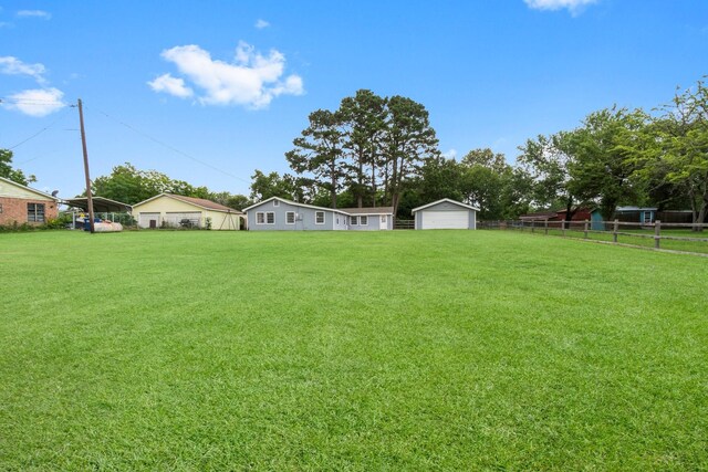 168 Bay Haven Blvd, Livingston, TX 77351 - view of yard featuring a garage and an outbuilding