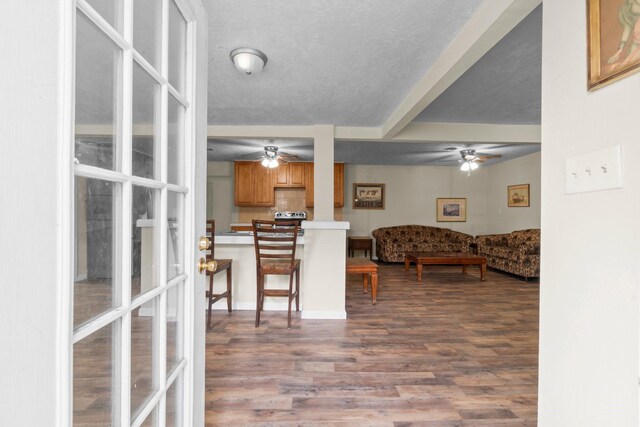 168 Bay Haven Blvd, Livingston, TX 77351 - living area featuring ceiling fan, dark wood-style flooring, and beamed ceiling