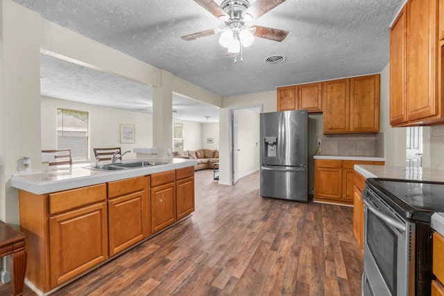 168 Bay Haven Blvd, Livingston, TX 77351 - kitchen featuring appliances with stainless steel finishes, a sink, a textured ceiling, light countertops, and a ceiling fan