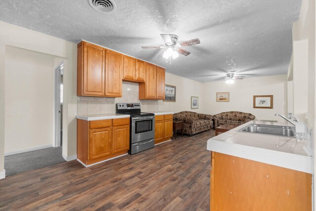 168 Bay Haven Blvd, Livingston, TX 77351 - kitchen with stainless steel electric stove, a sink, a ceiling fan, a textured ceiling, and dark wood-style flooring