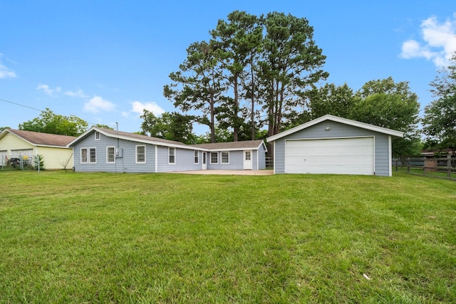 168 Bay Haven Blvd, Livingston, TX 77351 - rear view of house featuring a garage and an outdoor structure
