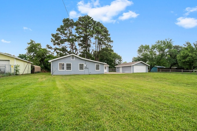168 Bay Haven Blvd, Livingston, TX 77351 - rear view of property with a garage and an outdoor structure