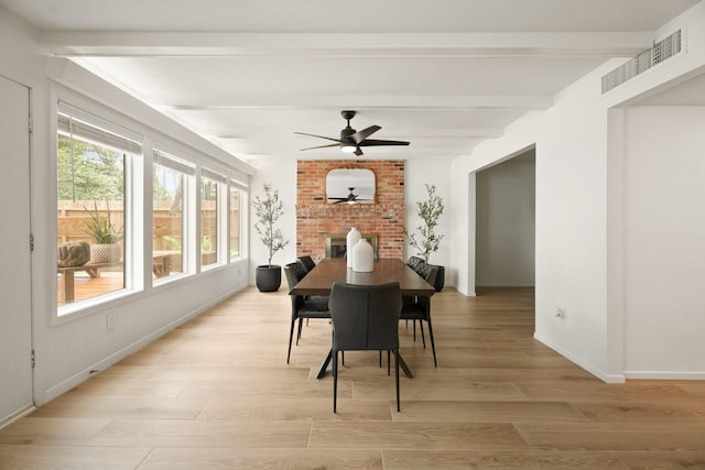 10907 Sagemeadow Ln, Houston, TX 77089 - dining room featuring beam ceiling, light wood finished floors, a ceiling fan, baseboards, and a brick fireplace