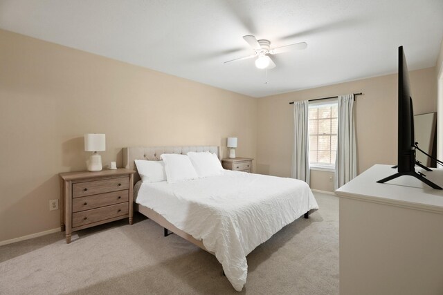 10907 Sagemeadow Ln, Houston, TX 77089 - bedroom with light colored carpet, a ceiling fan, and baseboards
