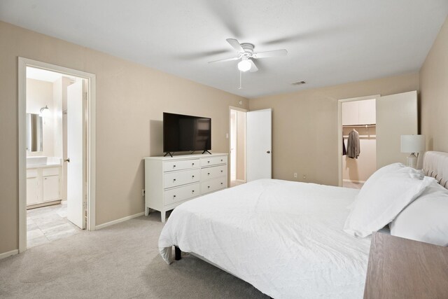 10907 Sagemeadow Ln, Houston, TX 77089 - bedroom featuring light carpet, baseboards, ensuite bath, and a ceiling fan