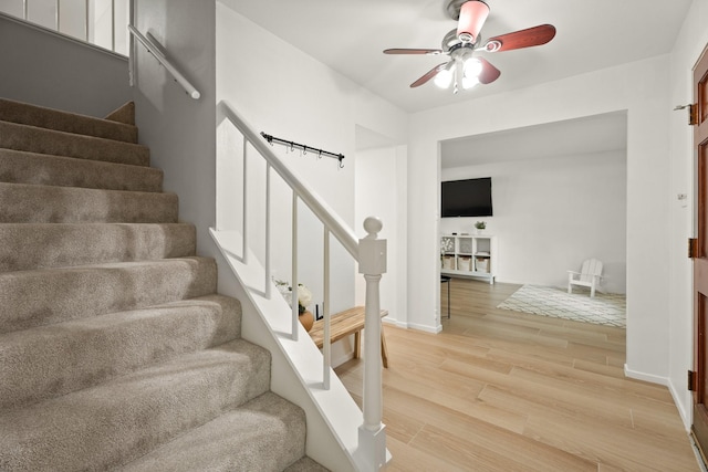10907 Sagemeadow Ln, Houston, TX 77089 - staircase with a ceiling fan, wood finished floors, and baseboards