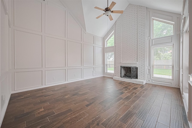 3406 Mesquite Dr, Sugar Land, TX 77479 - unfurnished living room featuring a decorative wall, a ceiling fan, dark wood-type flooring, a fireplace, and high vaulted ceiling