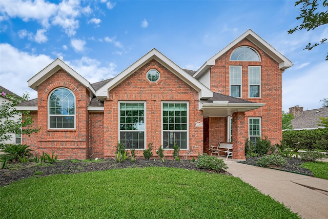 3406 Mesquite Dr, Sugar Land, TX 77479 - traditional-style home featuring brick siding, a front yard, and roof with shingles