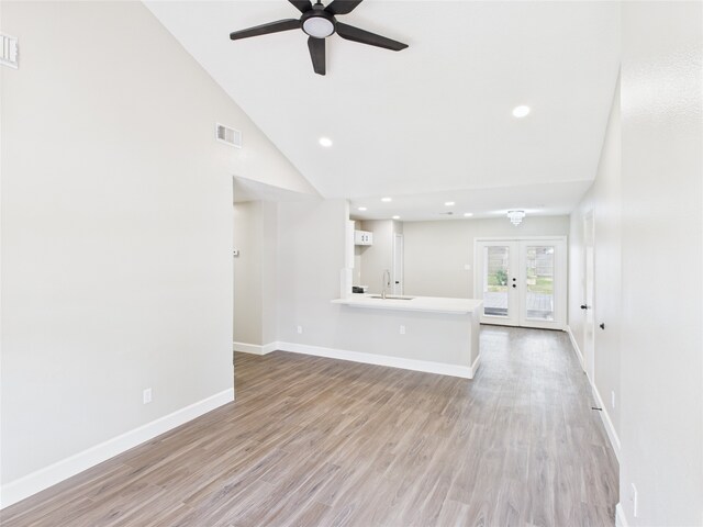 3219 Ricewood Dr, Porter, TX 77365 - unfurnished living room featuring ceiling fan, a sink, light wood finished floors, baseboards, and french doors
