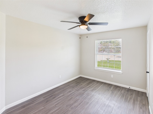 3219 Ricewood Dr, Porter, TX 77365 - unfurnished room featuring dark wood-style flooring, baseboards, and ceiling fan