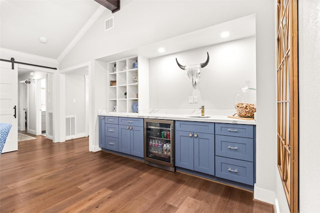 10618 Cranbrook Rd, Houston, TX 77042 - indoor wet bar featuring wine cooler, a barn door, dark wood finished floors, ornamental molding, and baseboards
