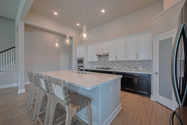 1718 Pepper Grove Ln, Katy, TX 77494 - kitchen featuring stainless steel appliances, a sink, tasteful backsplash, white cabinets, and recessed lighting