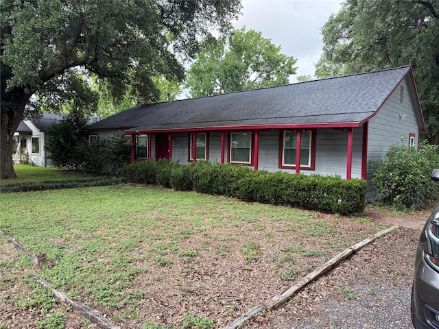 1707 Key St, Waller, TX 77484 - ranch-style home featuring a front lawn and a shingled roof