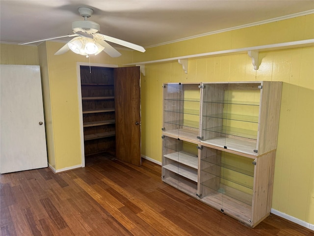 1707 Key St, Waller, TX 77484 - unfurnished bedroom featuring wood finished floors, baseboards, wood walls, and ornamental molding