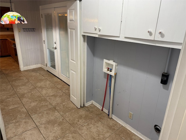1707 Key St, Waller, TX 77484 - laundry room featuring baseboards, hookup for a washing machine, light tile patterned flooring, and cabinet space