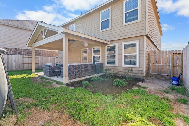 9915 Chimney Swift Ln, Conroe, TX 77385 - rear view of house with outdoor lounge area, a fenced backyard, and a patio