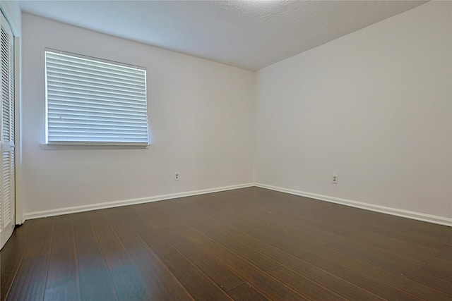 9910 Kent Towne Ln, Sugar Land, TX 77498 - spare room with baseboards and dark wood finished floors