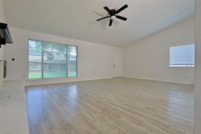 9910 Kent Towne Ln, Sugar Land, TX 77498 - unfurnished living room featuring lofted ceiling, light wood finished floors, ceiling fan, and baseboards