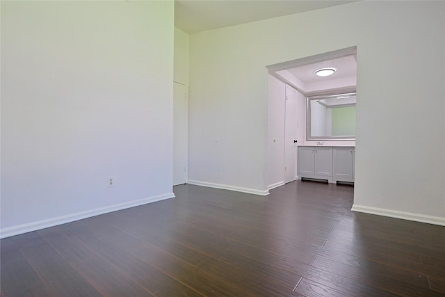 9910 Kent Towne Ln, Sugar Land, TX 77498 - spare room featuring baseboards and dark wood-type flooring