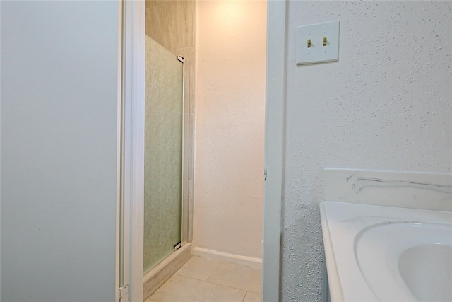 9910 Kent Towne Ln, Sugar Land, TX 77498 - bathroom featuring tile patterned floors, a shower stall, and baseboards