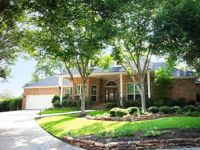 110 Canterbury Green Dr, Conroe, TX 77356 - ranch-style house with brick siding, concrete driveway, a front lawn, and a garage
