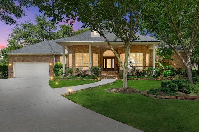 110 Canterbury Green Dr, Conroe, TX 77356 - view of front of home featuring brick siding, an attached garage, a yard, concrete driveway, and covered porch