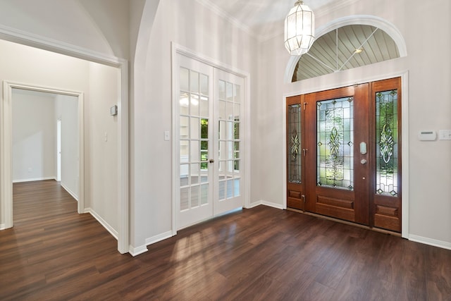 110 Canterbury Green Dr, Conroe, TX 77356 - foyer entrance featuring dark wood finished floors, a chandelier, and ornamental molding