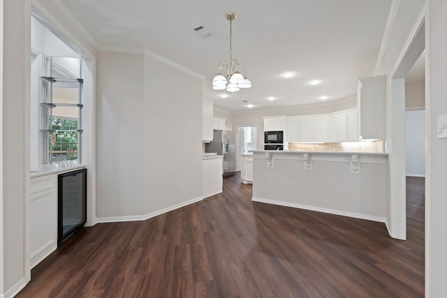 110 Canterbury Green Dr, Conroe, TX 77356 - kitchen featuring stainless steel fridge, black microwave, beverage cooler, dark wood-style flooring, and ornamental molding