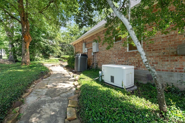 110 Canterbury Green Dr, Conroe, TX 77356 - view of side of home featuring brick siding and a cooling unit