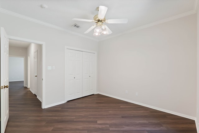 110 Canterbury Green Dr, Conroe, TX 77356 - unfurnished bedroom with dark wood-type flooring, a closet, ornamental molding, attic access, and a ceiling fan