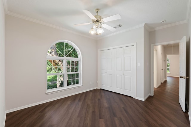 110 Canterbury Green Dr, Conroe, TX 77356 - unfurnished bedroom featuring attic access, multiple windows, dark wood-style flooring, a closet, and ornamental molding