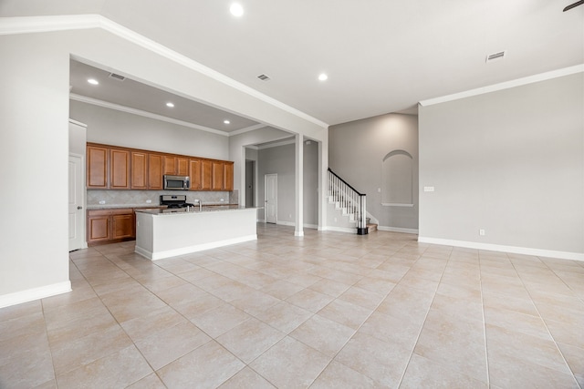18738 Fox Kestrel Trl, Cypress, TX 77429 - kitchen with appliances with stainless steel finishes, light tile patterned floors, brown cabinetry, open floor plan, and recessed lighting