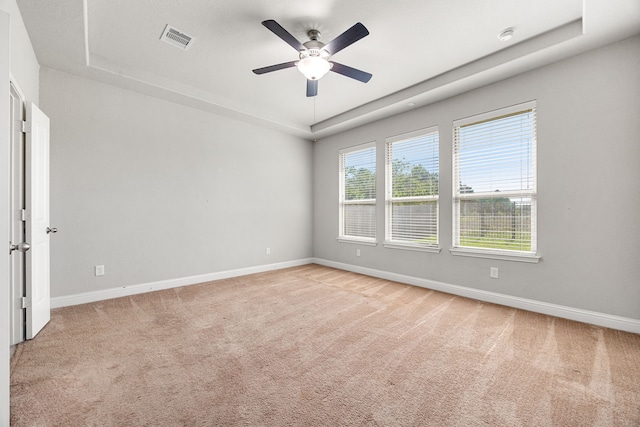 18738 Fox Kestrel Trl, Cypress, TX 77429 - spare room featuring a raised ceiling, baseboards, light carpet, and ceiling fan