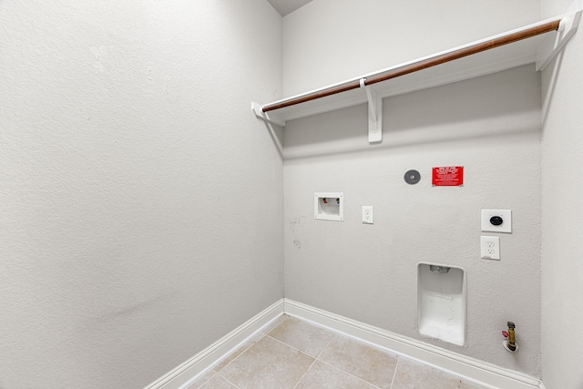 18738 Fox Kestrel Trl, Cypress, TX 77429 - laundry area featuring hookup for a gas dryer, hookup for an electric dryer, baseboards, light tile patterned flooring, and hookup for a washing machine