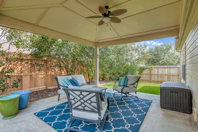4609 Woodspring Acres Ct, Kingwood, TX 77345 - fenced backyard featuring a ceiling fan, an outdoor hangout area, and a patio area