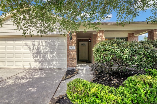 4609 Woodspring Acres Ct, Kingwood, TX 77345 - entrance to property with brick siding, concrete driveway, and an attached garage
