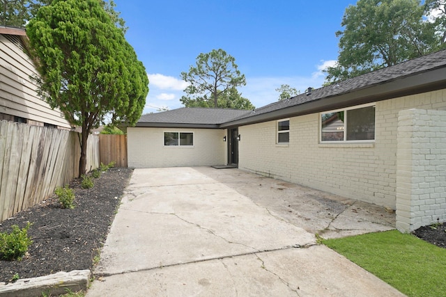 15322 E Barbara Cir, Houston, TX 77071 - rear view of property featuring brick siding, a patio, and roof with shingles