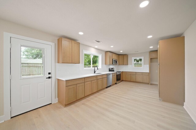 15322 E Barbara Cir, Houston, TX 77071 - kitchen featuring stainless steel appliances, decorative backsplash, light wood-type flooring, recessed lighting, and light countertops