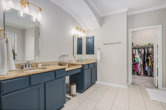 16618 S Swirling Cloud Ct, Cypress, TX 77433 - bathroom with double vanity, baseboards, crown molding, a walk in closet, and tile patterned floors