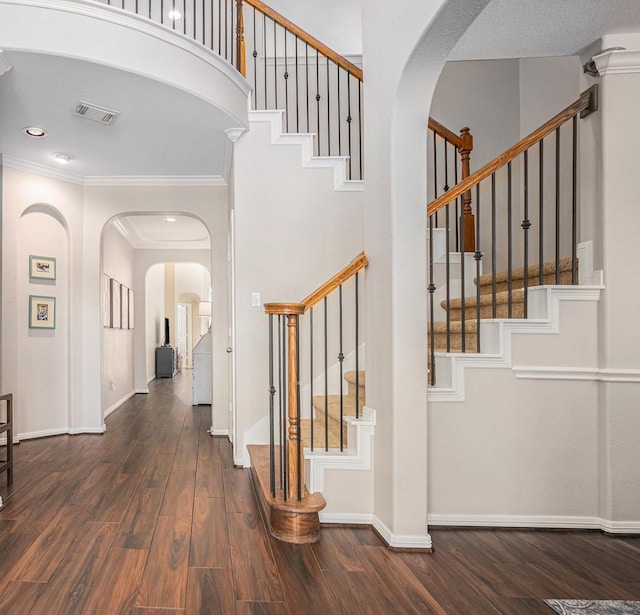 16618 S Swirling Cloud Ct, Cypress, TX 77433 - foyer featuring arched walkways, stairway, dark wood-type flooring, baseboards, and ornamental molding