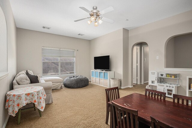 16618 S Swirling Cloud Ct, Cypress, TX 77433 - living area featuring ceiling fan, carpet flooring, and arched walkways