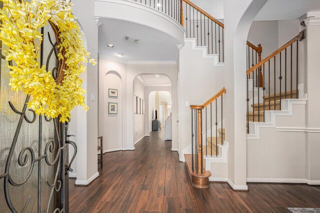 16618 S Swirling Cloud Ct, Cypress, TX 77433 - foyer entrance with arched walkways, dark wood-style floors, crown molding, stairway, and baseboards