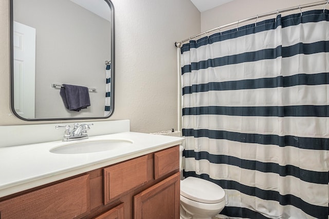 16618 S Swirling Cloud Ct, Cypress, TX 77433 - bathroom with toilet, vanity, a shower with shower curtain, and a textured wall