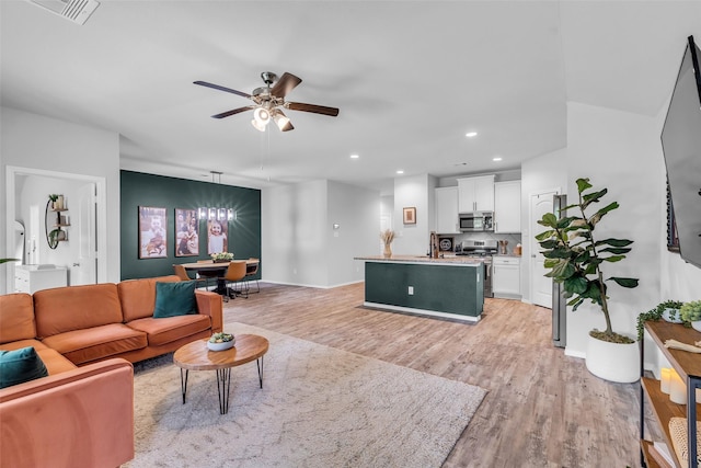 2322 Strong Horse Dr, Conroe, TX 77301 - living area featuring light wood-type flooring, a chandelier, a ceiling fan, and recessed lighting