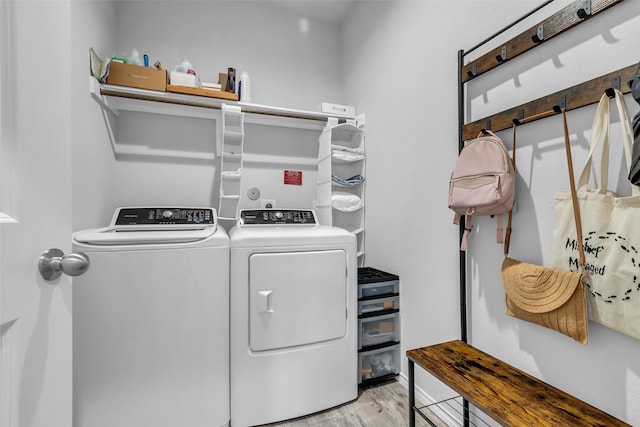 2322 Strong Horse Dr, Conroe, TX 77301 - laundry room featuring washing machine and clothes dryer and light wood-style flooring