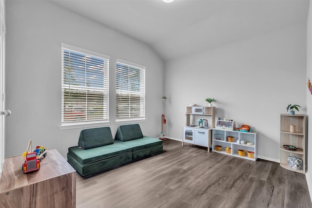 2322 Strong Horse Dr, Conroe, TX 77301 - sitting room with wood finished floors, vaulted ceiling, and baseboards