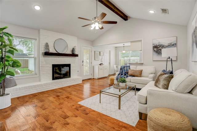 12427 Attlee Dr, Houston, TX 77077 - living area featuring ceiling fan, plenty of natural light, a fireplace, and light wood finished floors